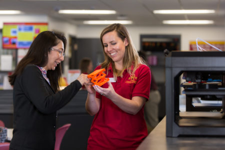 Students examining 3D print